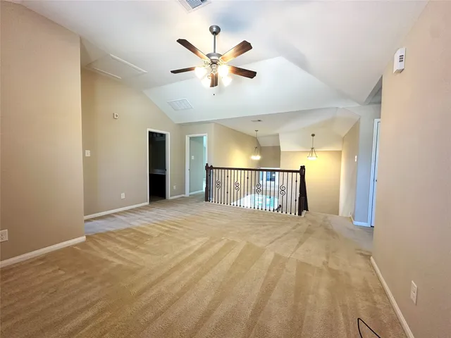 a view of a livingroom with a ceiling fan and wooden floor