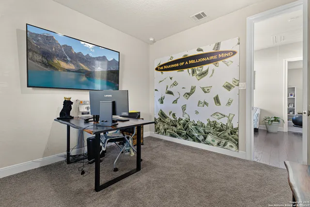 a view of a workspace with furniture and a potted plant