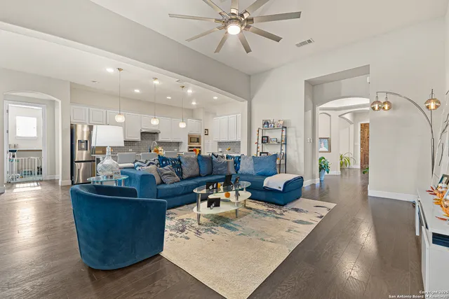 a living room with furniture and a chandelier