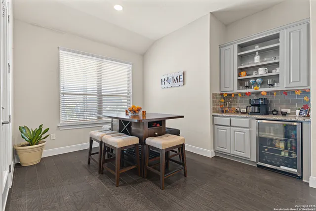 a dining room with furniture and window
