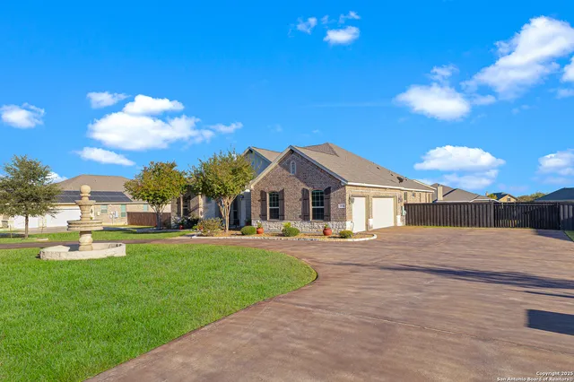 a front view of a house with a yard and lake view
