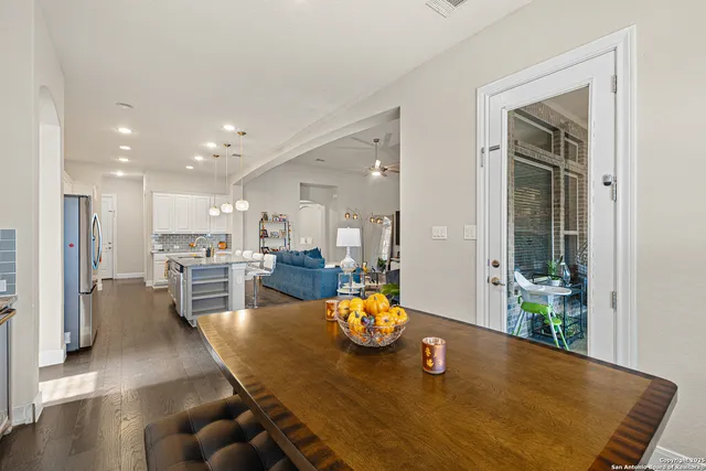 a dining room with furniture and a view of kitchen