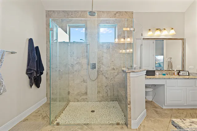 a bathroom with a shower and a sink