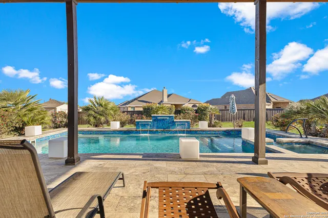 a view of a balcony with chair and wooden floor