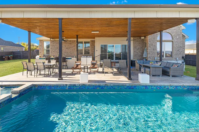 a view of a swimming pool with outdoor seating