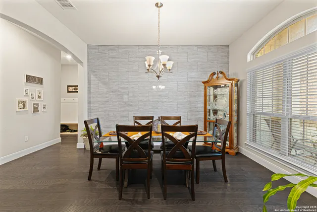 a view of a dining room with furniture and chandelier