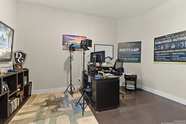 a view of a workspace with furniture and a window