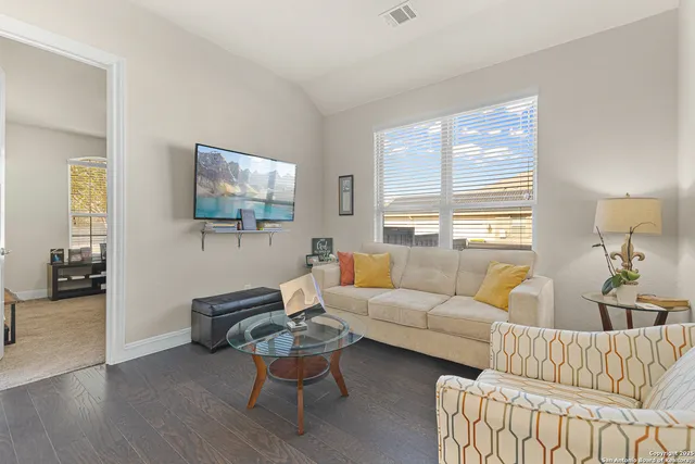 a living room with furniture and a flat screen tv