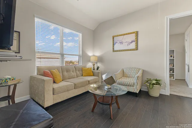 a living room with furniture and wooden floor
