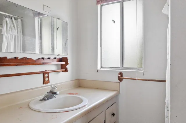 a bathroom with a sink and a mirror