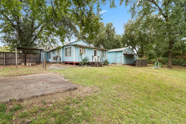 a front view of house with yard and green space
