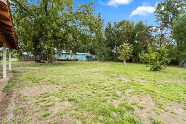 a view of a green yard with a house