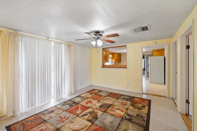a view of an empty room and a window