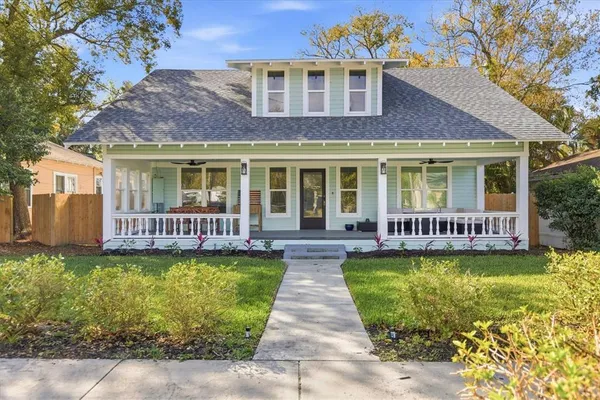 a view of a house with a garden and swimming pool