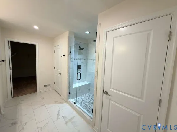 a bathroom with a shower and a glass door