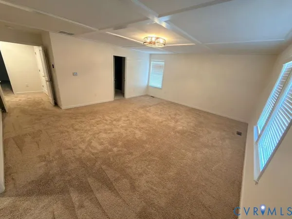 a view of an empty room with a mirror