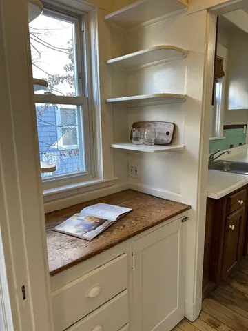 a kitchen with a sink a stove and a window