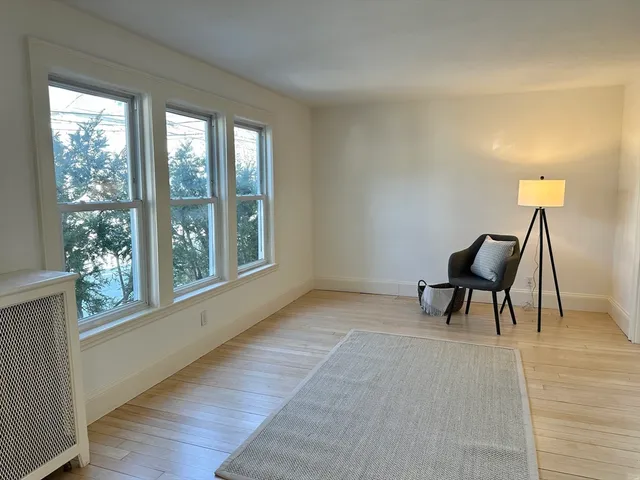 a view of a livingroom with furniture and a window