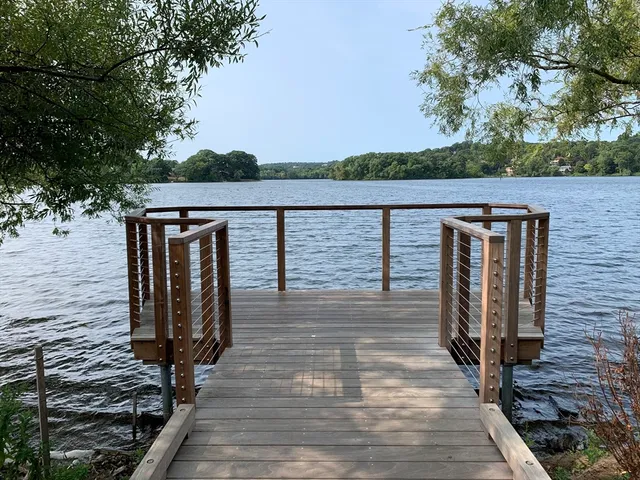 a view of balcony with wooden floor and fence