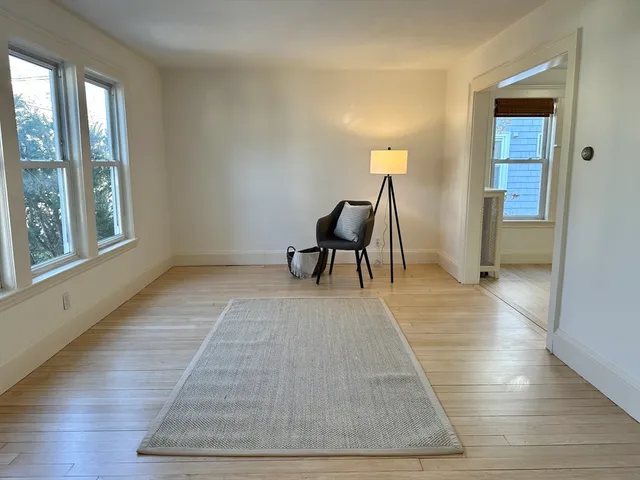 a view of a room with wooden floor and furniture