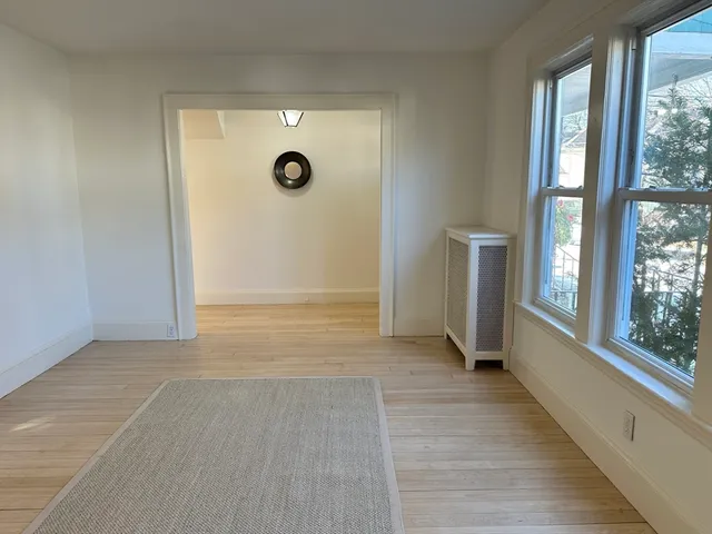 an empty room with windows and entrance