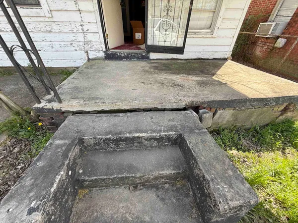 a view of a dry yard with wooden fence