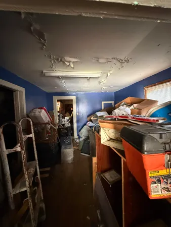 a bedroom with two beds and a chandelier