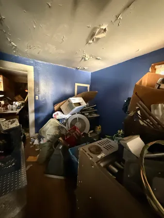 a living room with furniture a flat screen tv and a window
