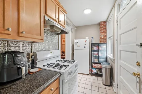 a kitchen with a stove and a refrigerator