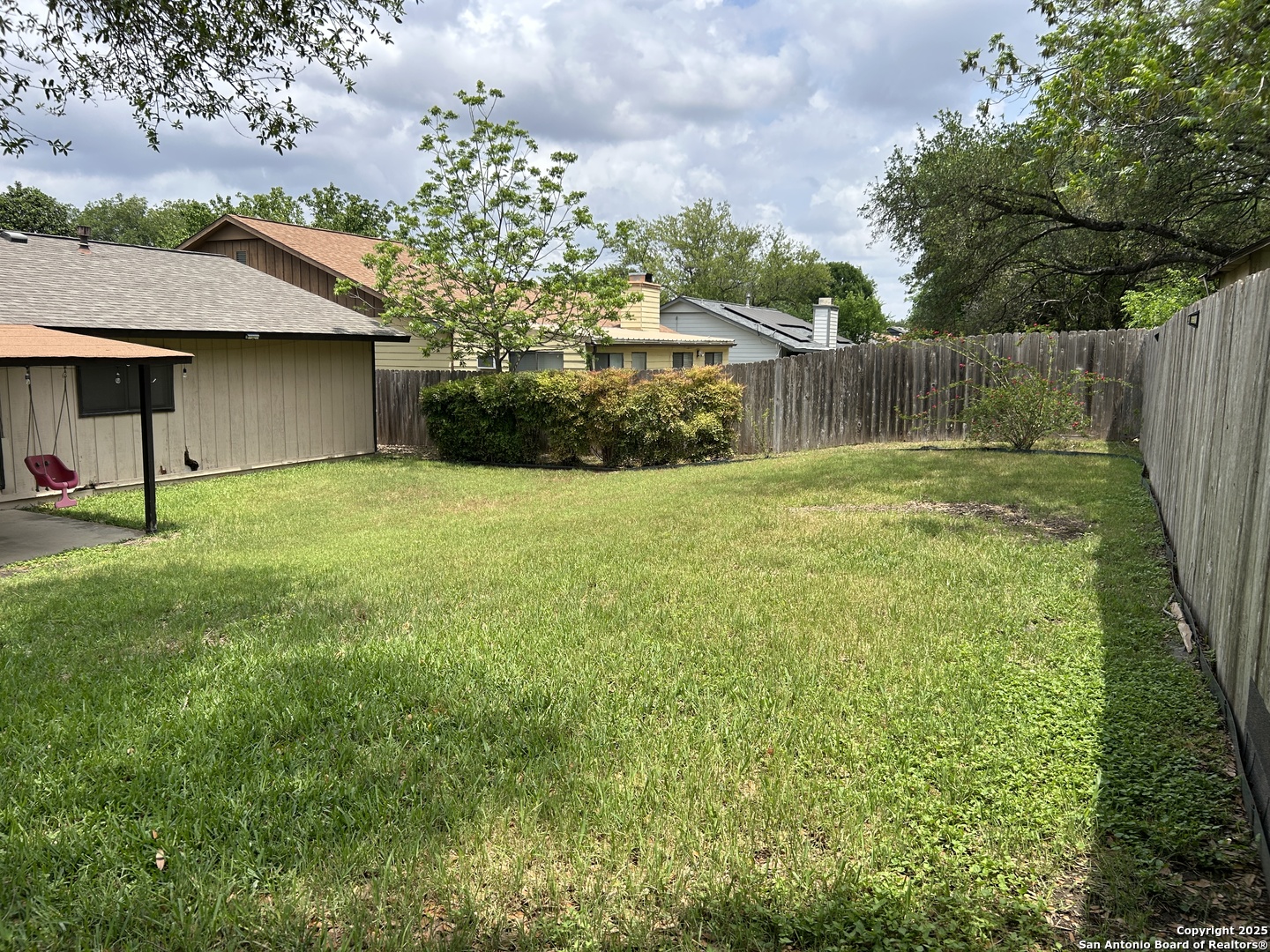 5938 Kissing Oak Street San Antonio, TX 78247 - Photo 10 of 11 a view of a garden with a house in the background