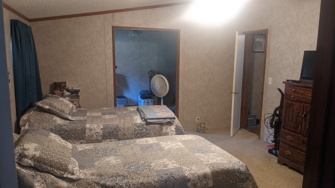 599 Little Fiery Road Sequatchie, TN 37374 - Photo 19 of 34 a bedroom with a bed and a flat tv screen on the dresser