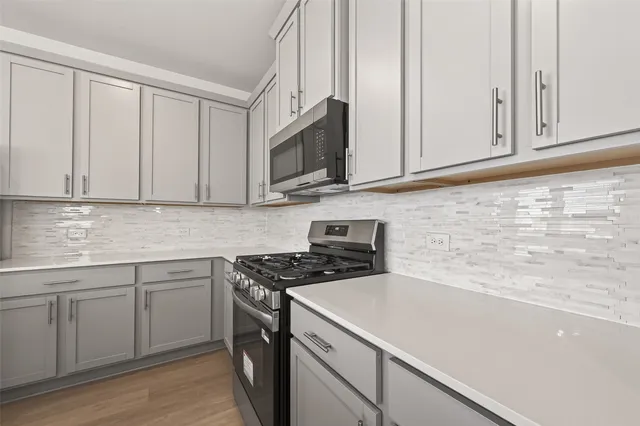 a kitchen with stainless steel appliances granite countertop white cabinets a sink and dishwasher