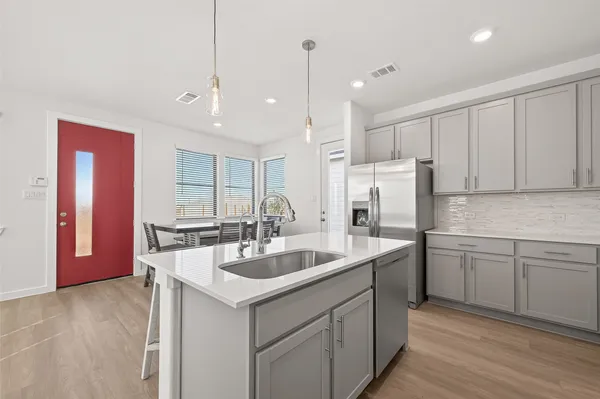 a kitchen with sink cabinets and stainless steel appliances