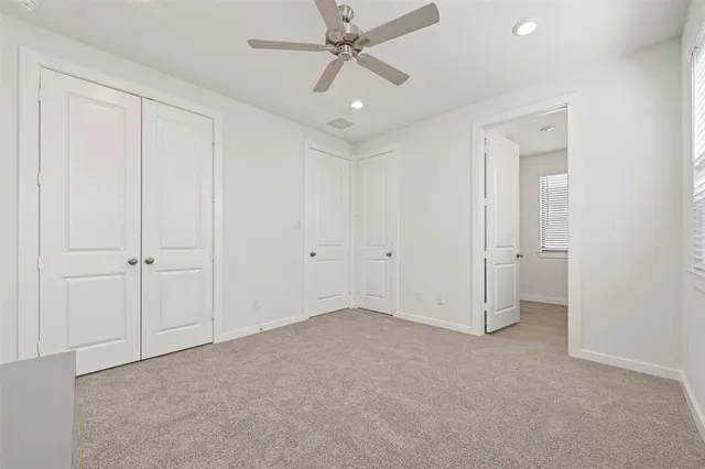 wooden floor in an empty room and a ceiling fan