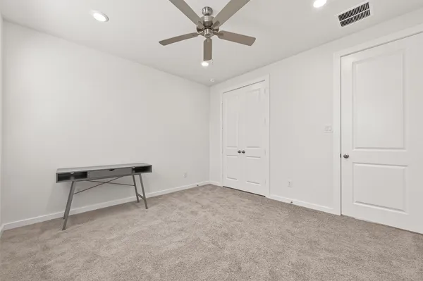an empty room with a ceiling fan