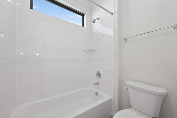 a bathroom with a toilet and a bathtub