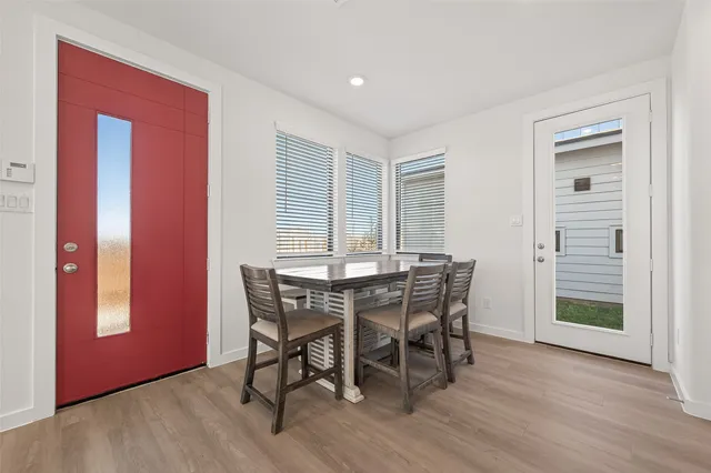 a view of a dining room with furniture and wooden floor