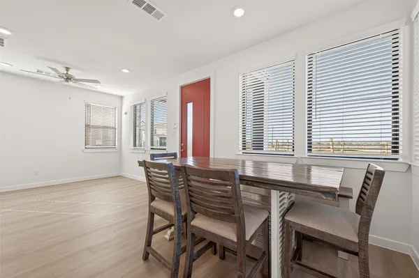 a view of a dining room with furniture and windows