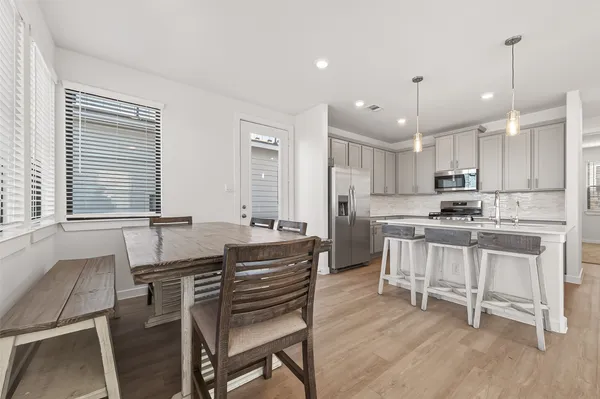 a kitchen with kitchen island granite countertop a sink and white appliances