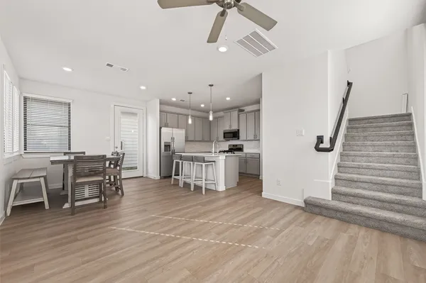 a view of kitchen with furniture and wooden floor