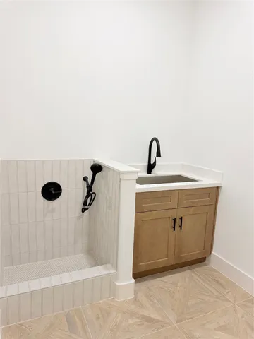 a bathroom with a sink vanity and shower