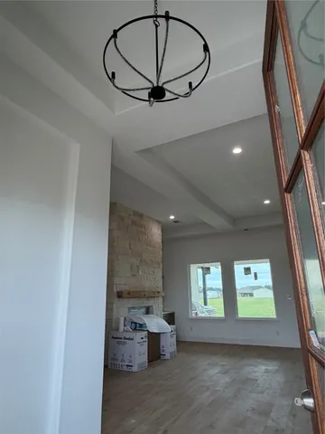 a view of a room with window and hardwood floor