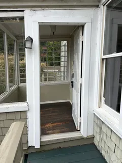 an empty room with windows and entrance