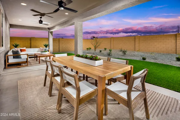a view of a house with backyard porch and sitting area
