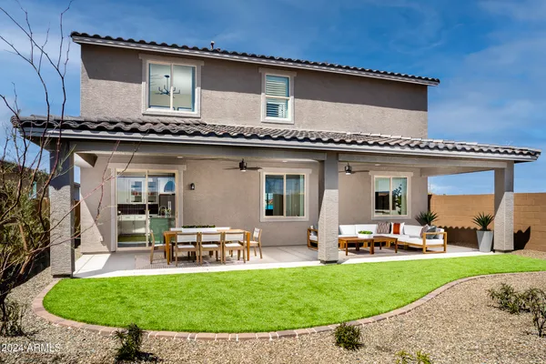 a kitchen with stainless steel appliances kitchen island granite countertop a stove a refrigerator and white cabinets