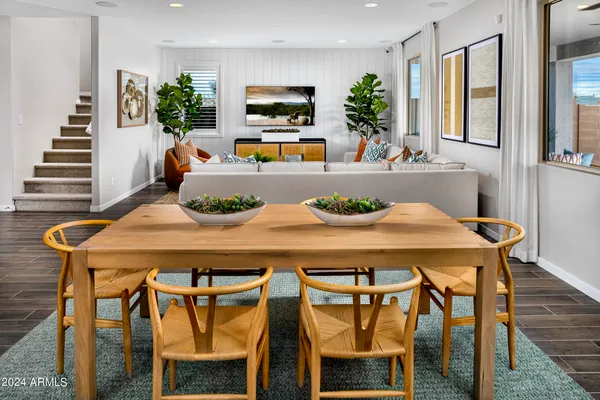 a living room with furniture a flat screen tv and a large window