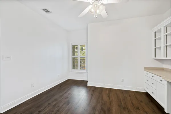 a room with cabinets and wooden floor