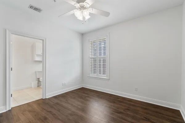 a view of an empty room with wooden floor