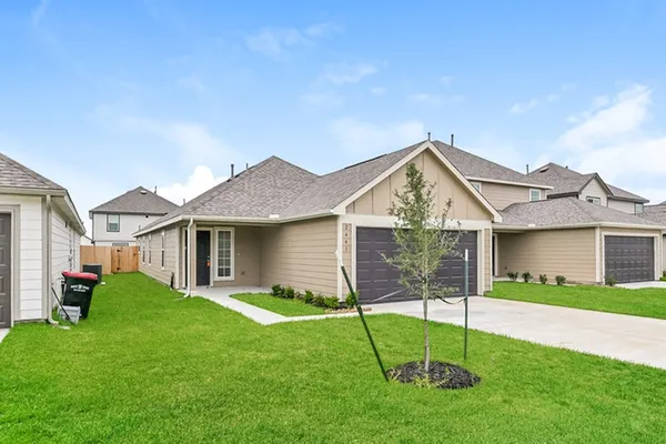 a view of a house with a yard and a garden