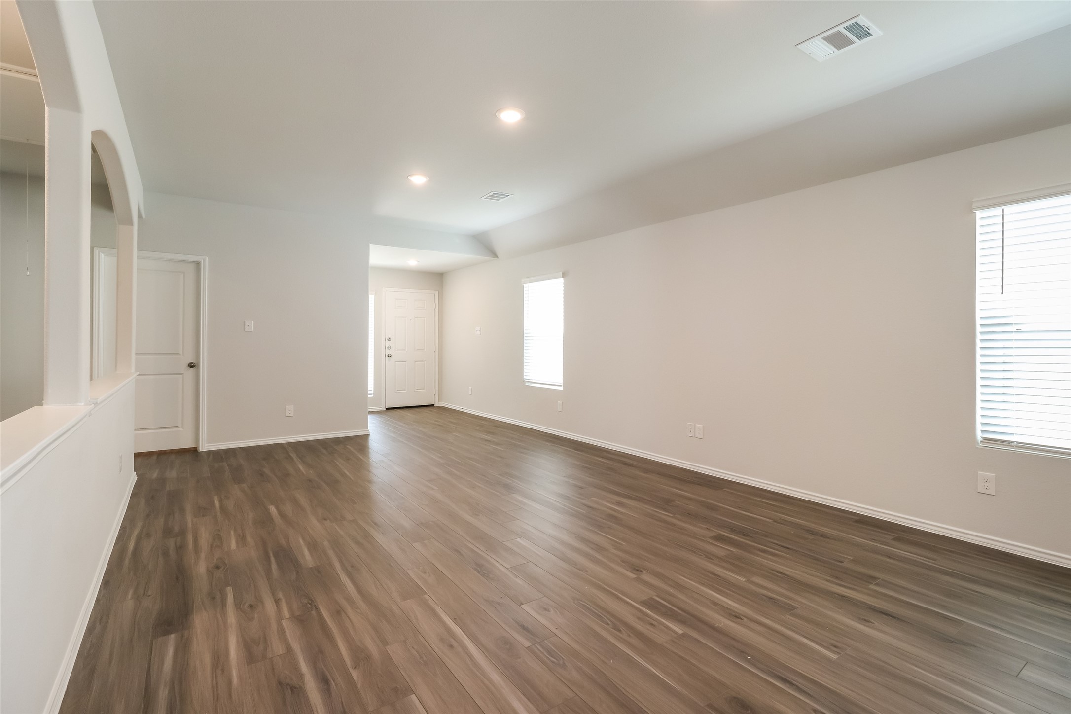 2441 Flathead Drive Conroe, TX 77384 - Photo 10 of 18 an empty room with wooden floor and windows